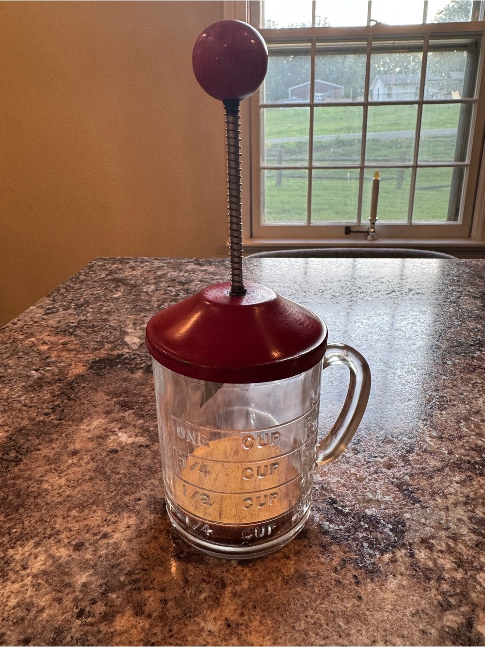 Vintage Hazel Atlas glass kitchen chopper with red lid and ball handle